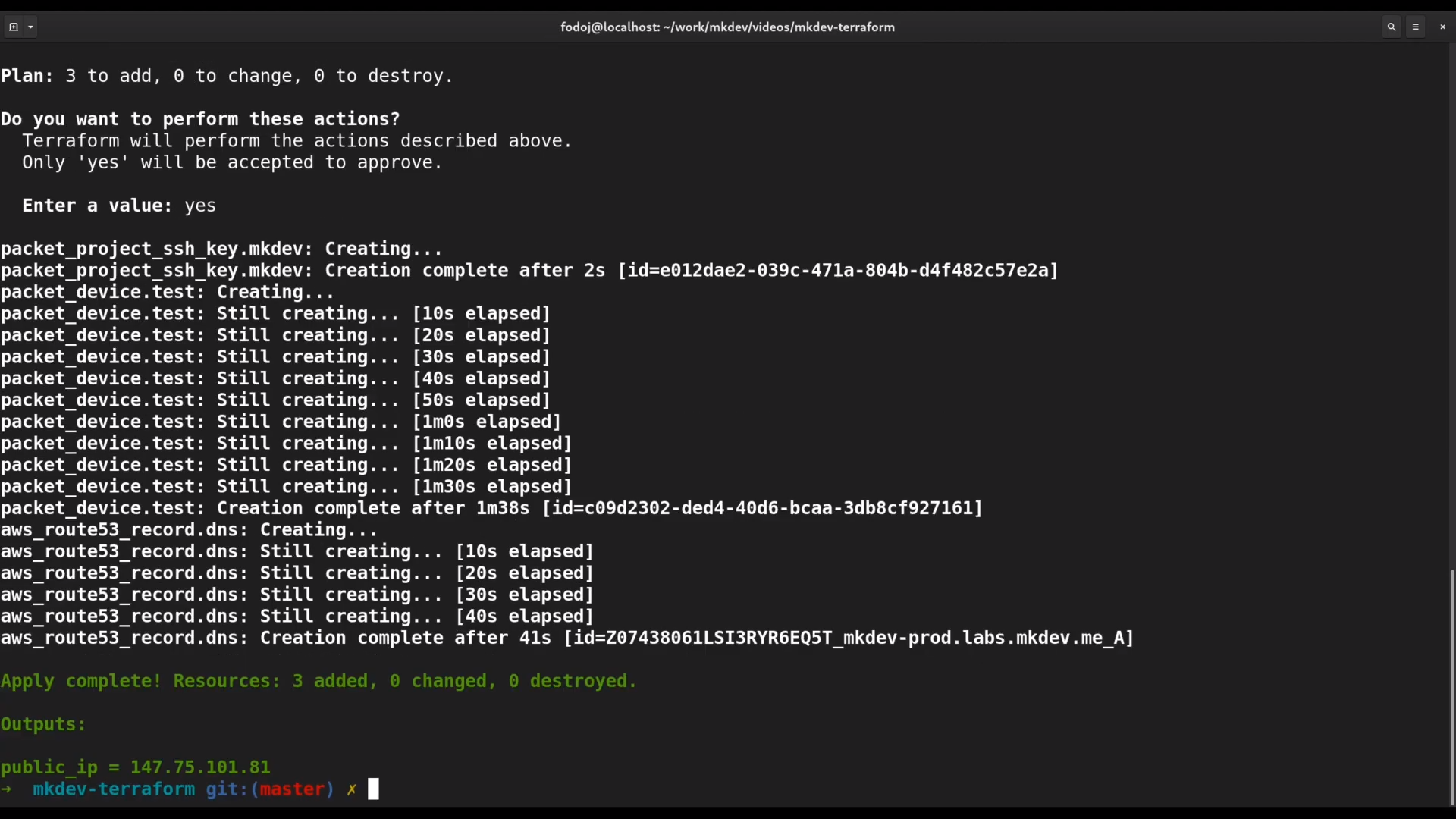 Terminal screen showing the execution of a Terraform apply command with progress logs indicating the creation of resources and a final output with a public IP address.